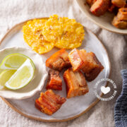 Air fryer chicharrones with tostones and lemon wedges