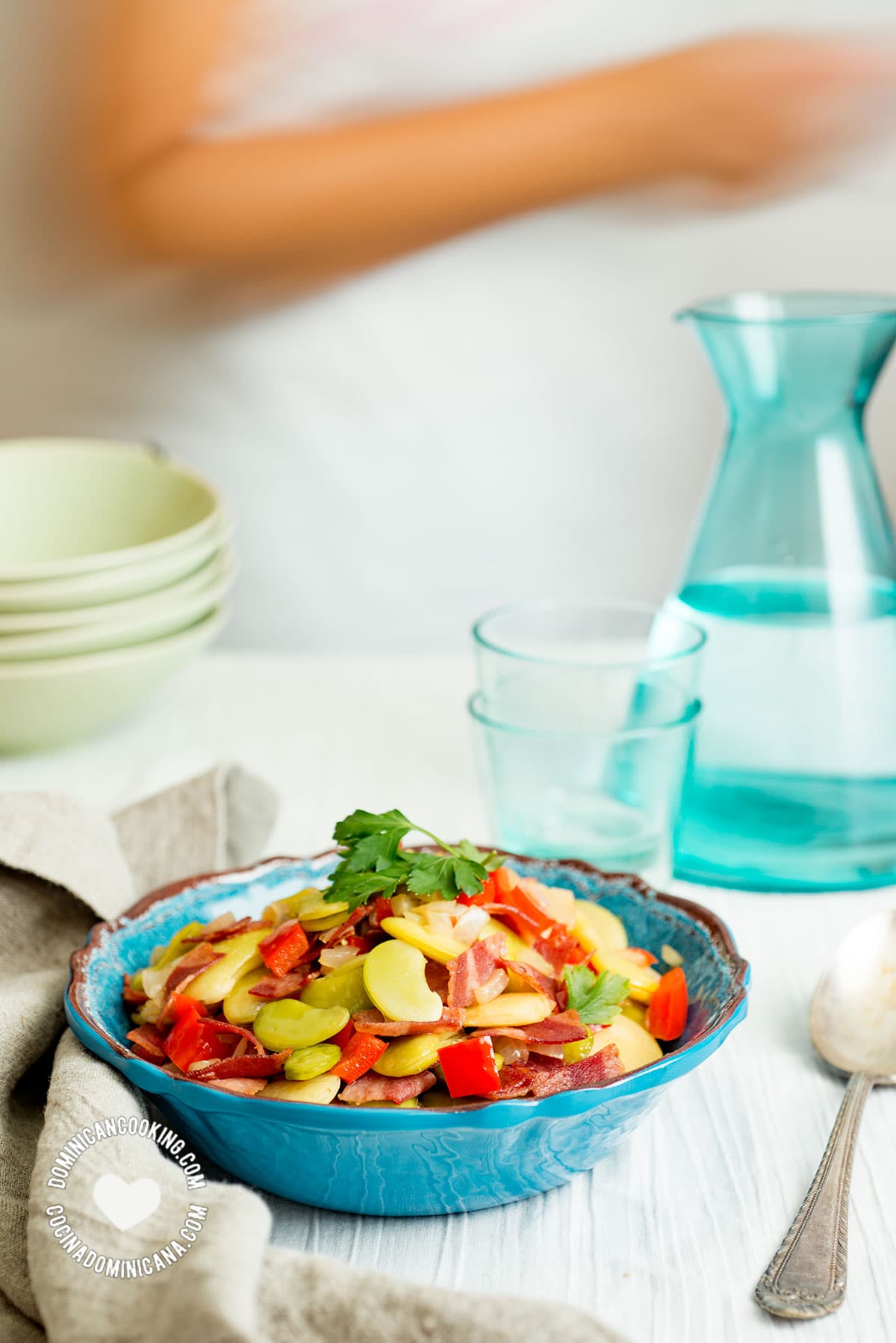 Fava bean and bacon salad, person passing behind table