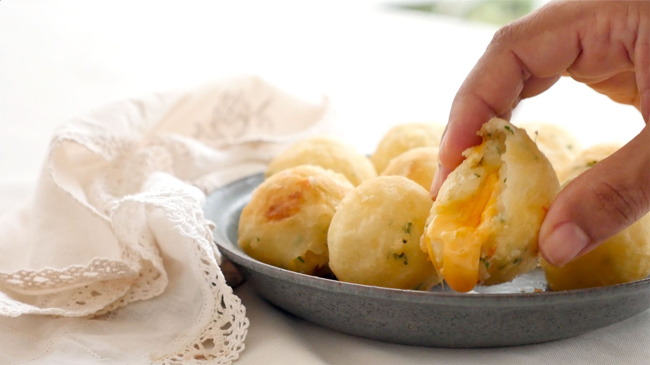 Serving yuca balls stuffed with cheese on plate