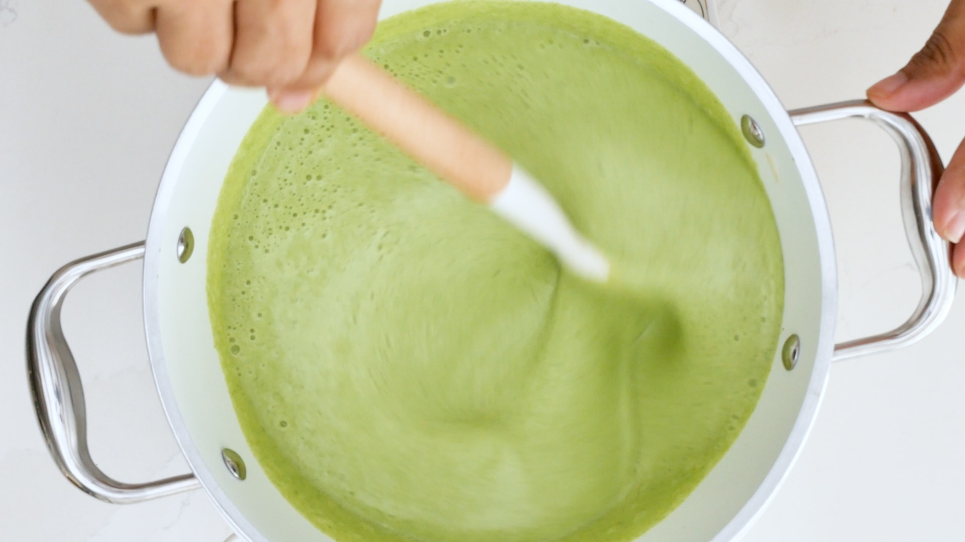 Stirring cream of broccoli and potato cheese