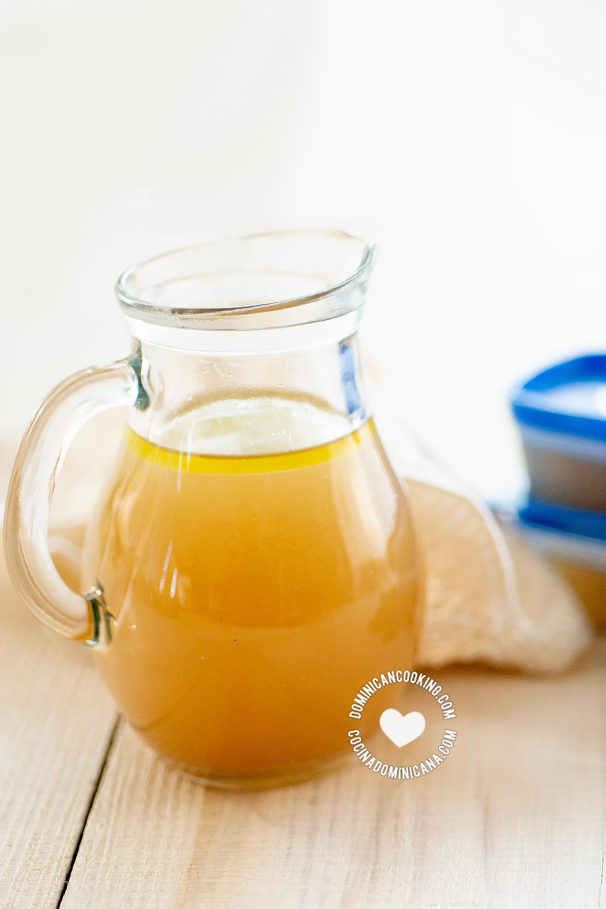 Jar and cups of homemade chicken broth