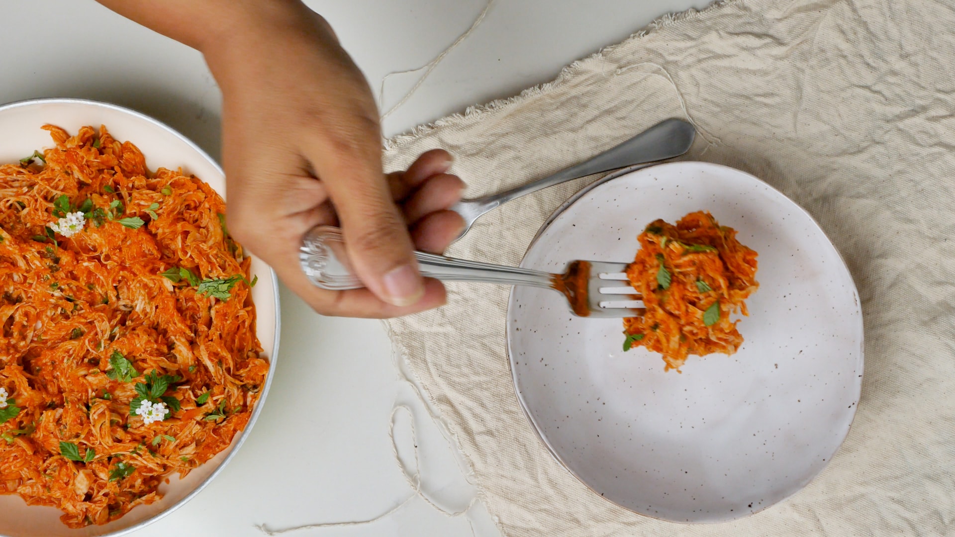 Serving chicken from skillet to plate