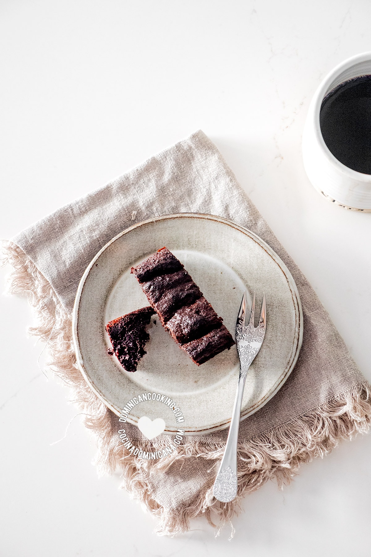 Slice of chocolate cake and a cup of coffee from above