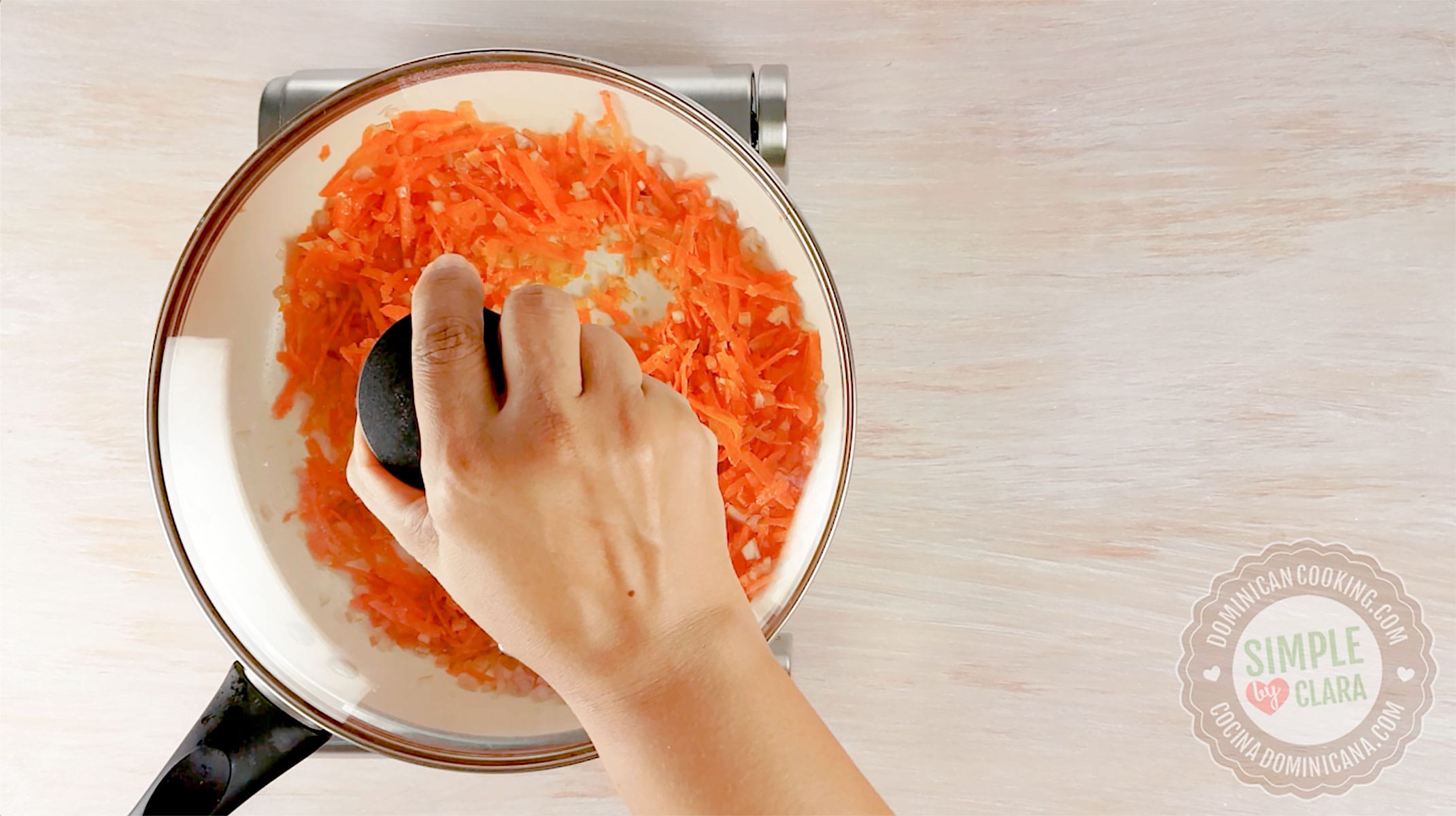 Covering skillet with carrot and onion