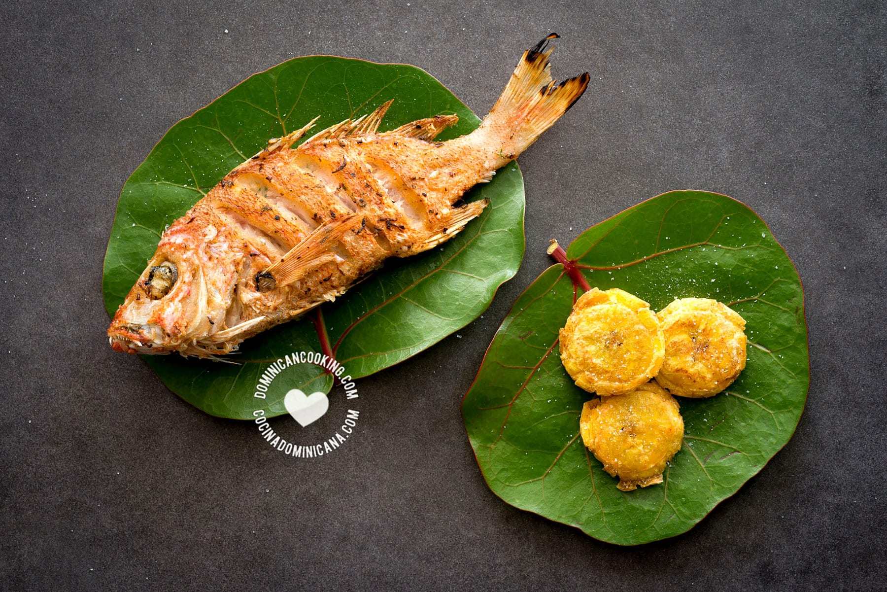 Fried fish (pescado frito) on leaves with fried plantains