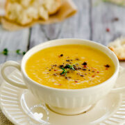 Bowl of Cream of Arracacha and Ginger Soup (Cepa de Apio) served with Bread