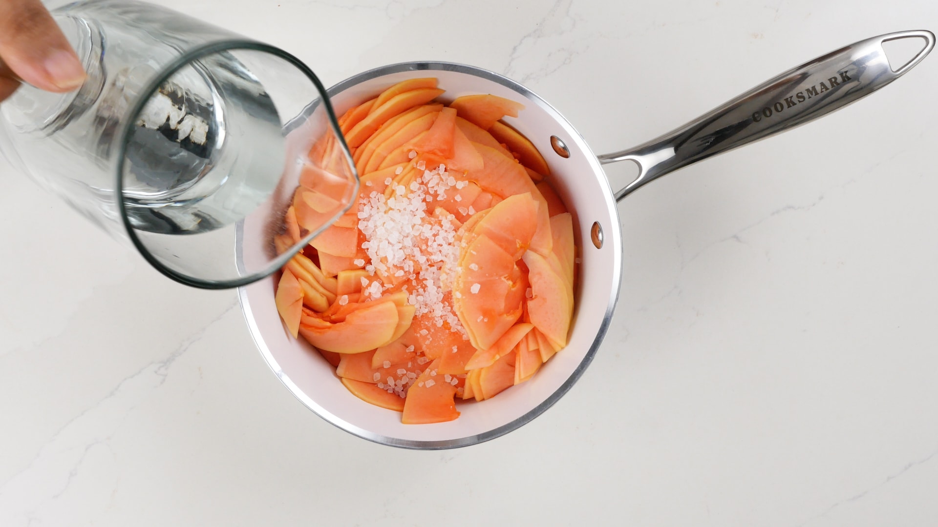 Adding salt and water to papaya