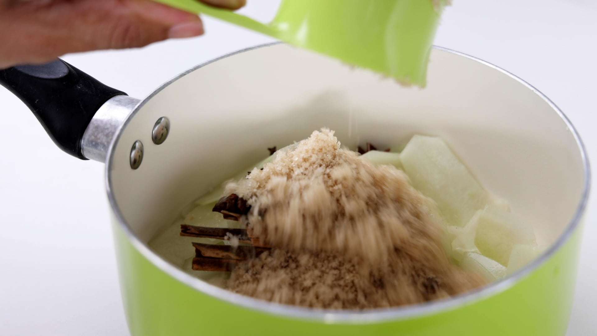 Adding sugar to the saucepan