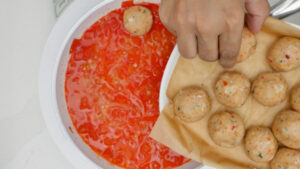 Putting fish balls in the sauce