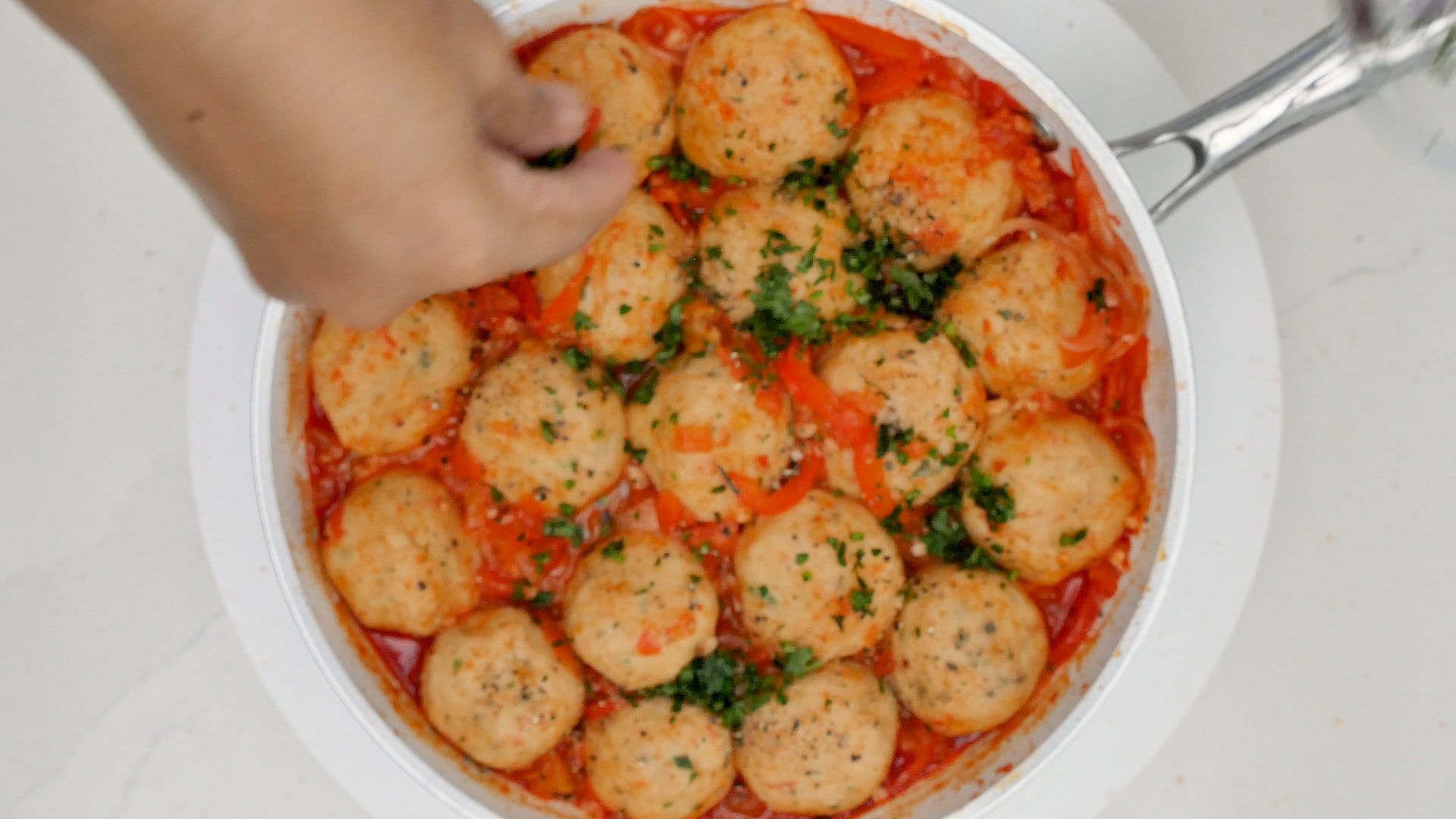 Adding parsley to fish balls