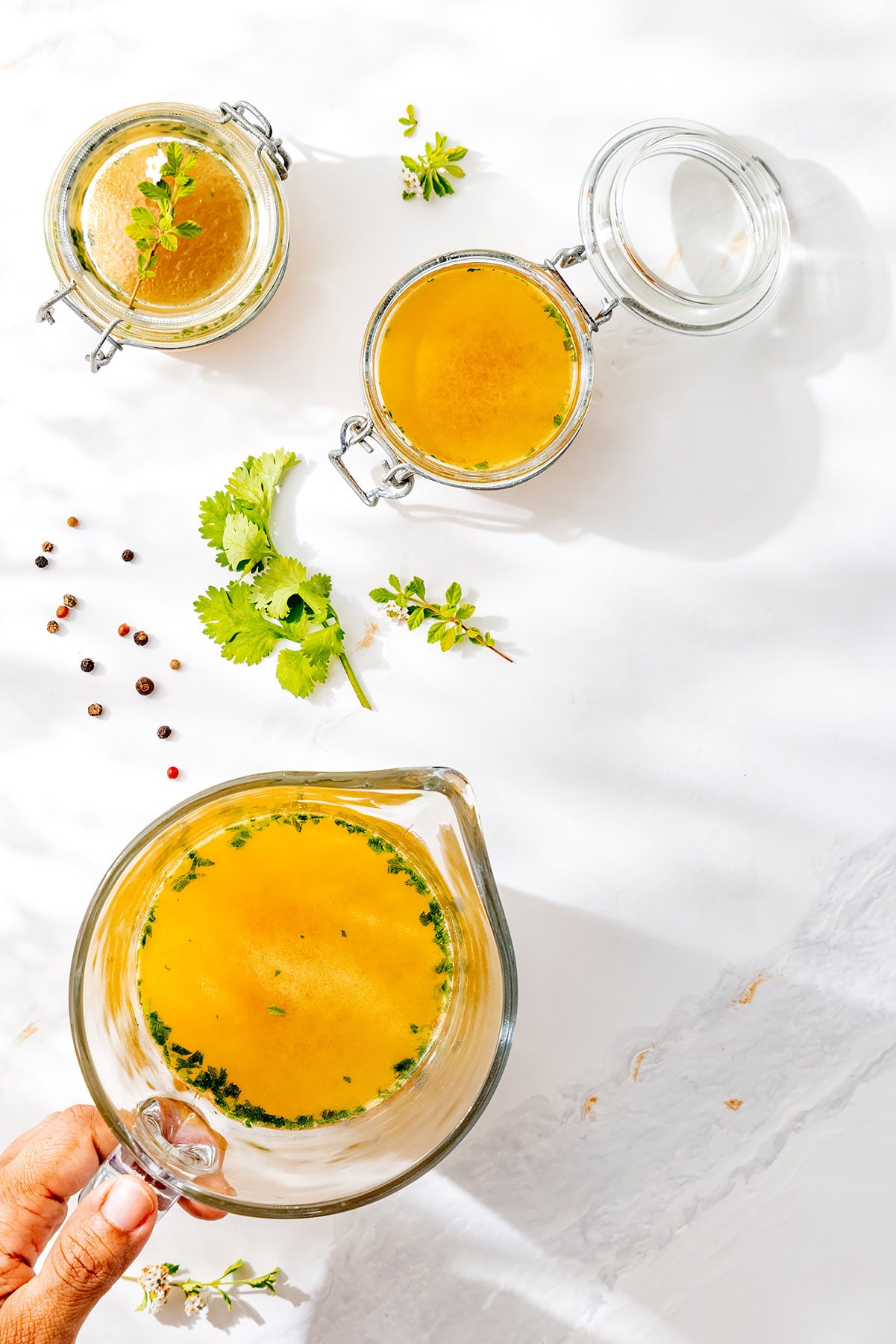 Vegetable broth in jars and pitcher