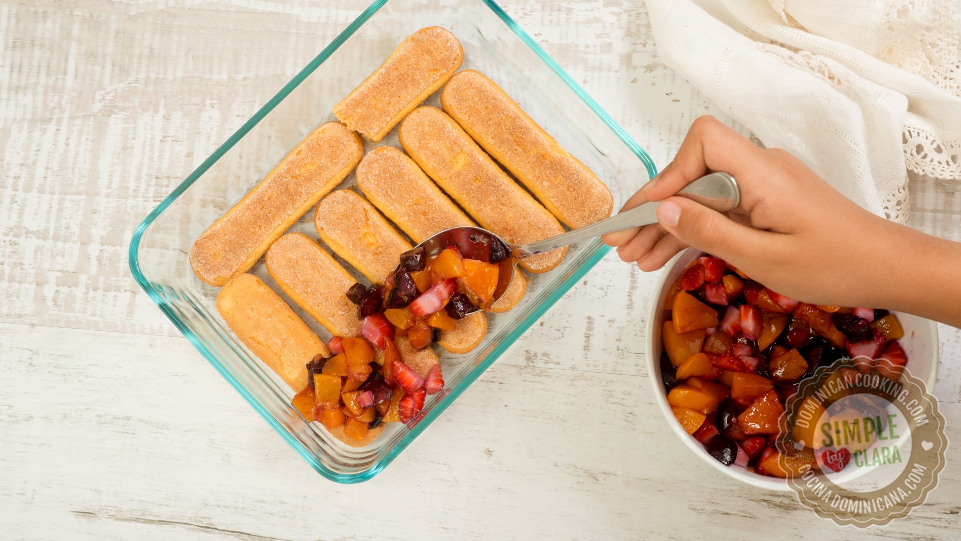 Layering fruit over ladyfingers