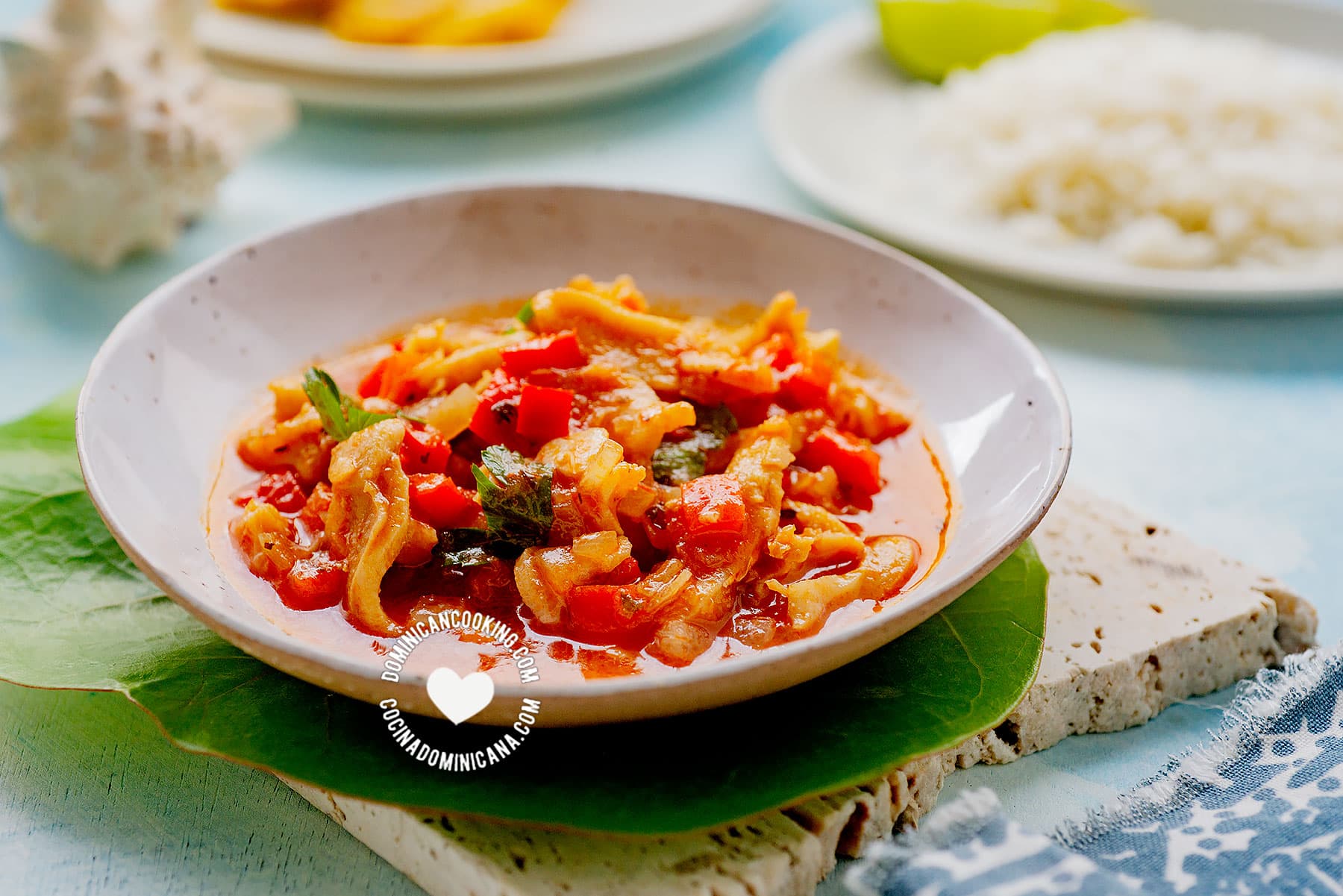 Lambí guisado (caribbean conch stew) served with rice and tostones