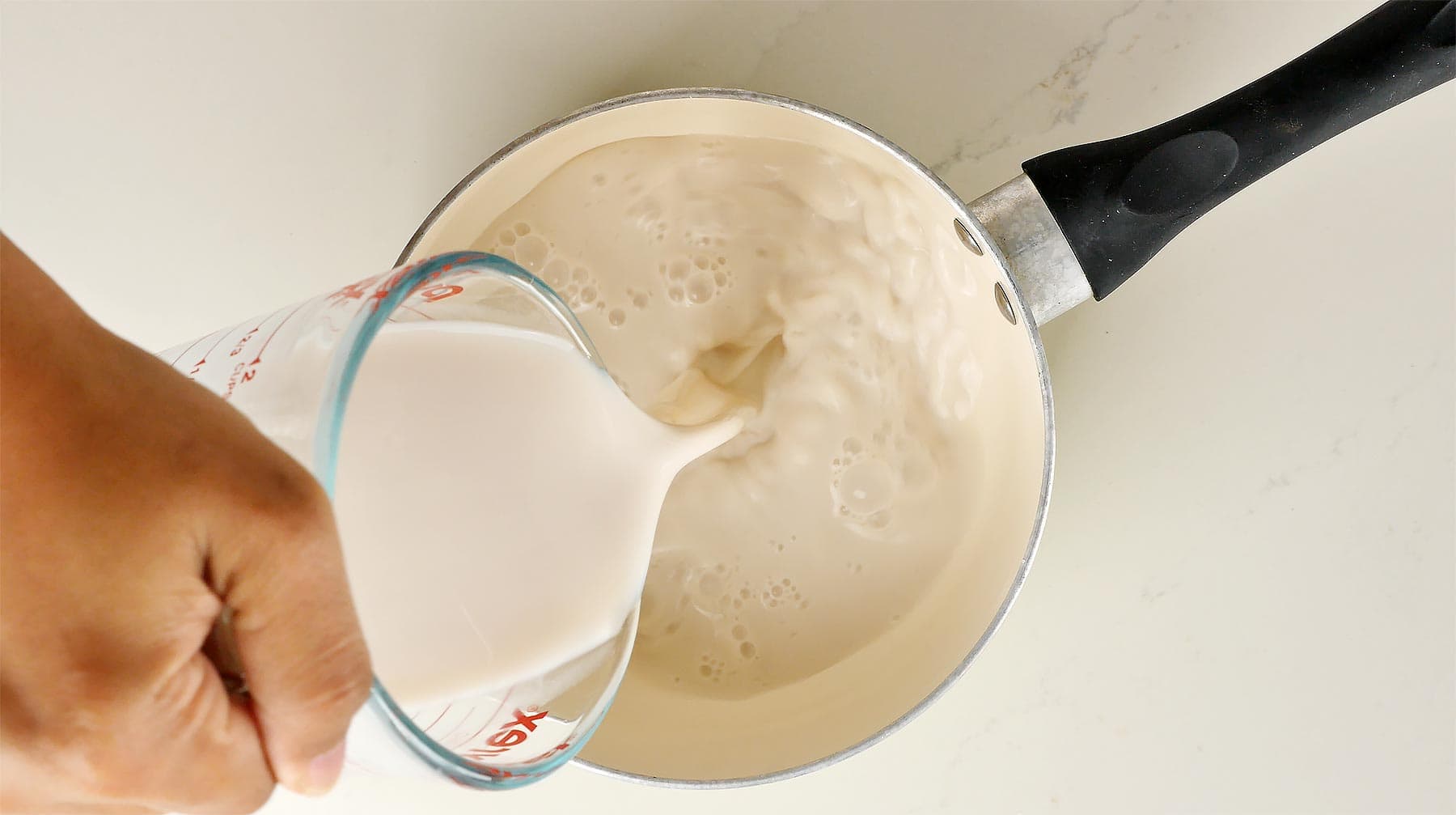 Pouring milk into the saucepan