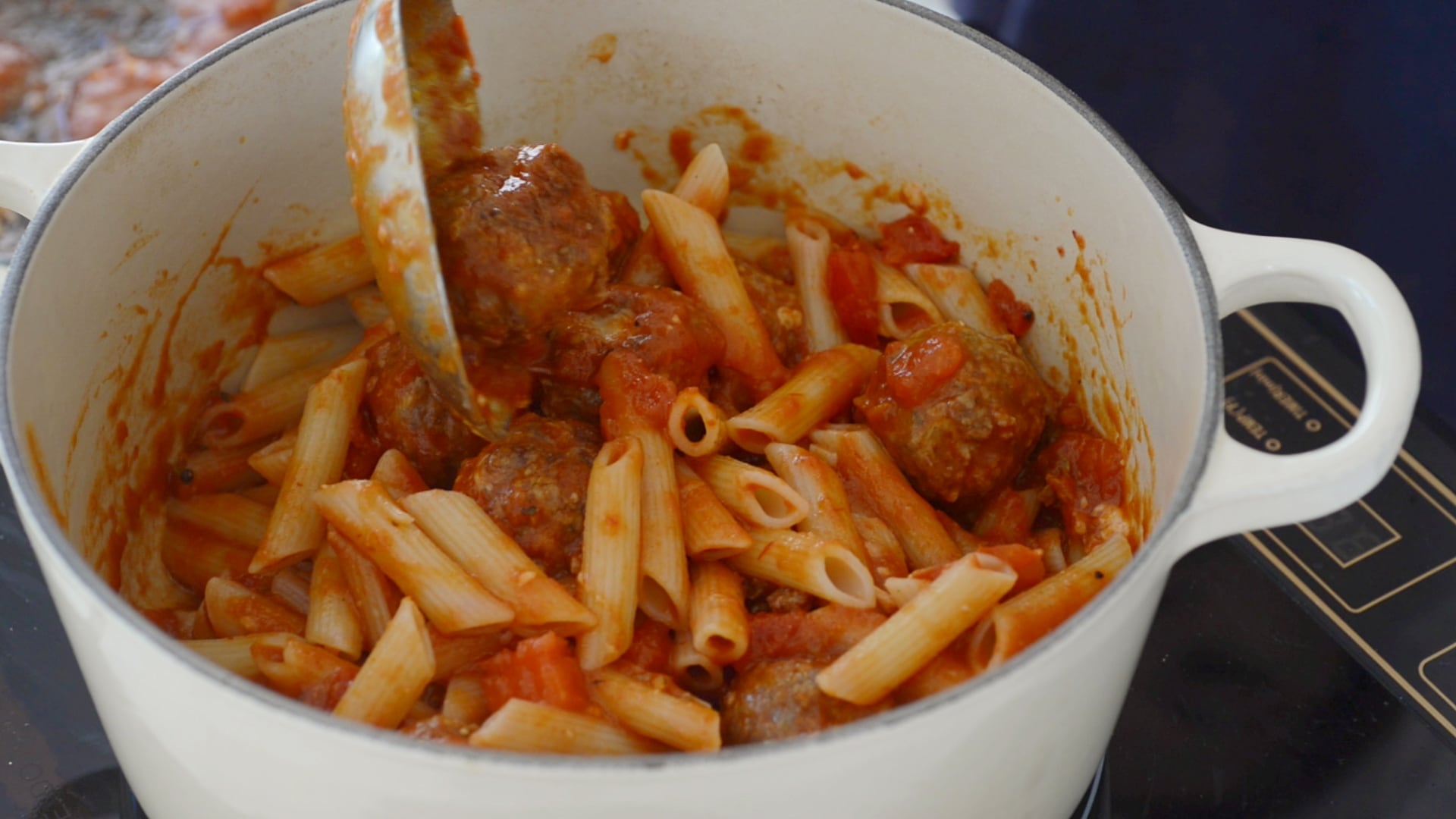 Mixing pasta and meatballs