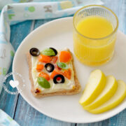 Whole Wheat Cheese and Veggies Tartlet Served with juice and an apple slices