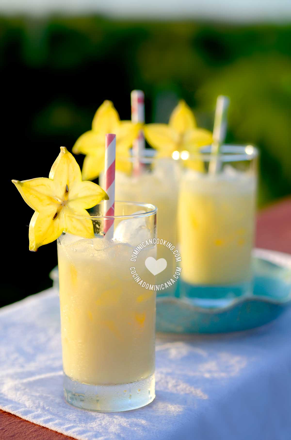 Three glasses of morir soñando (Dominican orange julius) with starfruit decoration