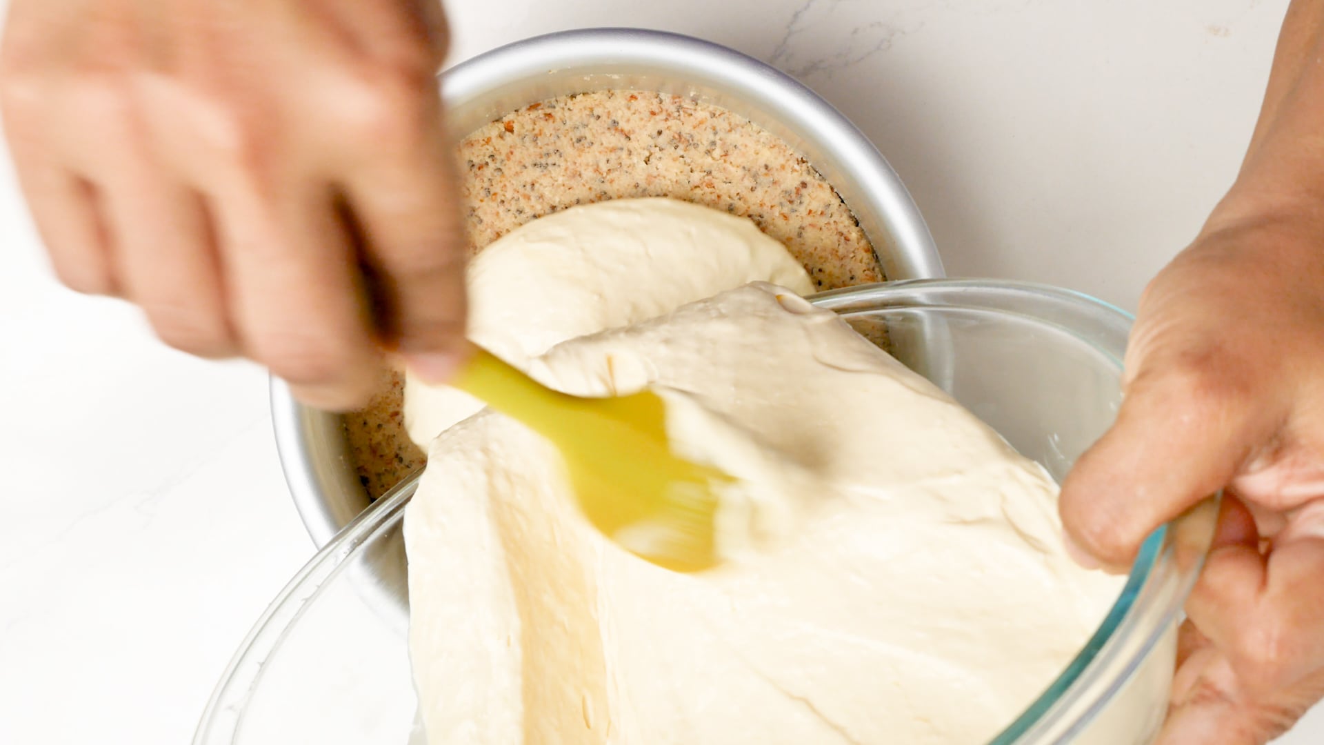 Pouring cream cheese mix into pan