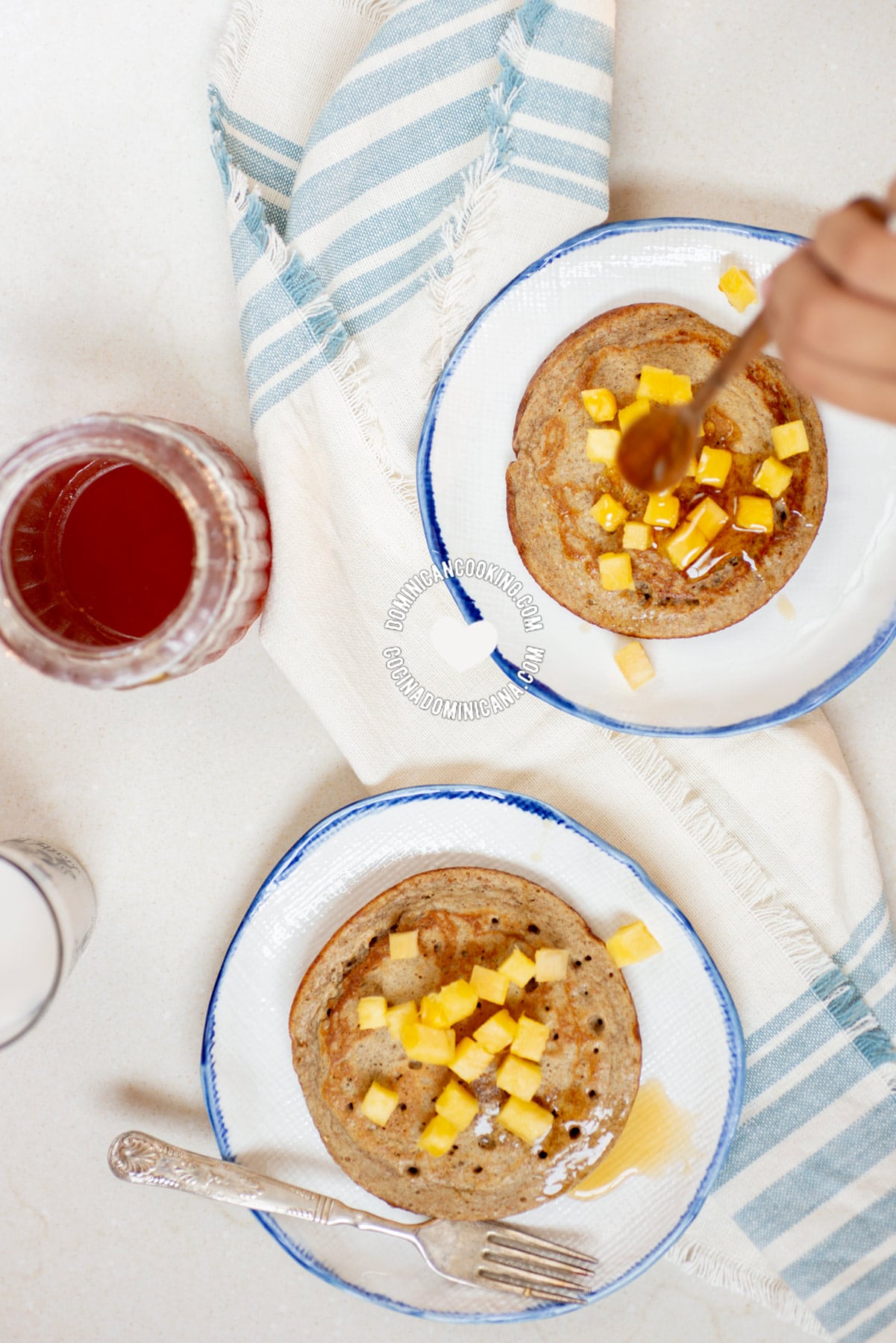 Pouring honey on Whole Wheat and Banana Sugar-Free Pancakes