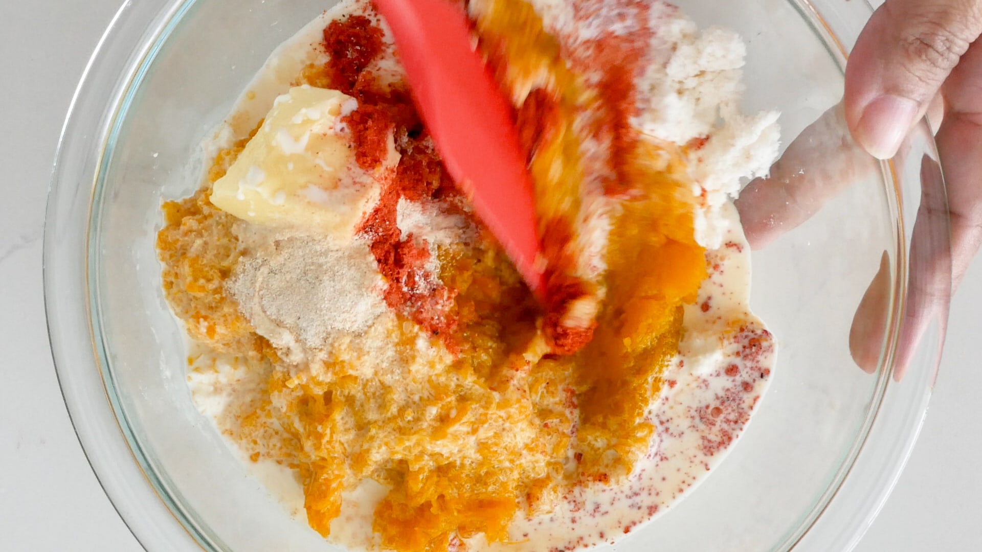 Mixing ingredients for pasteles de yuca