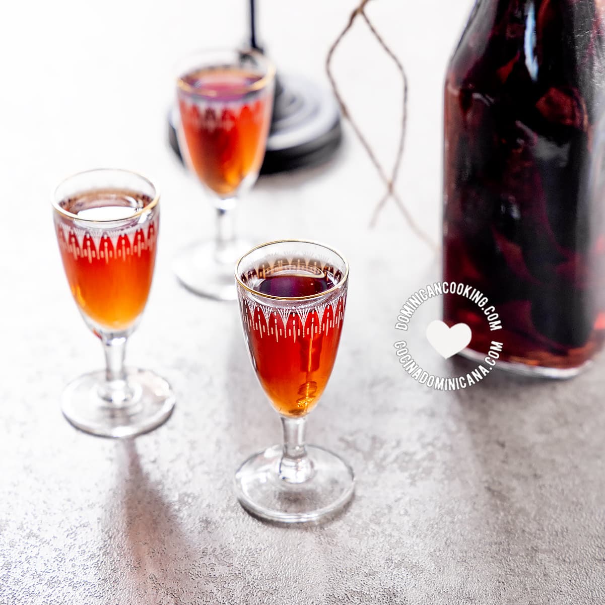 Glass shots and bottle of mamajuana spiced Dominican drink