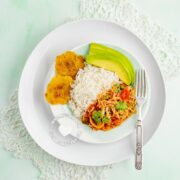 Repollo Guisado (Stewed Cabbage) served with rice and avocado