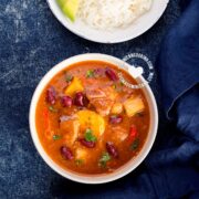 Bowl of Sancocho de Habichuelas or Sopión or Zambumbio (Sweet & Spicy Bean Stew) Served with Rice and Avocado Slices