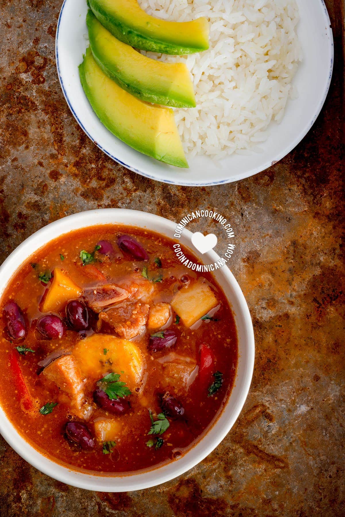 Bowl of Sancocho de Habichuelas or Sopión or Zambumbio (Sweet & Spicy Bean Stew) Served with Rice and Avocado Slices