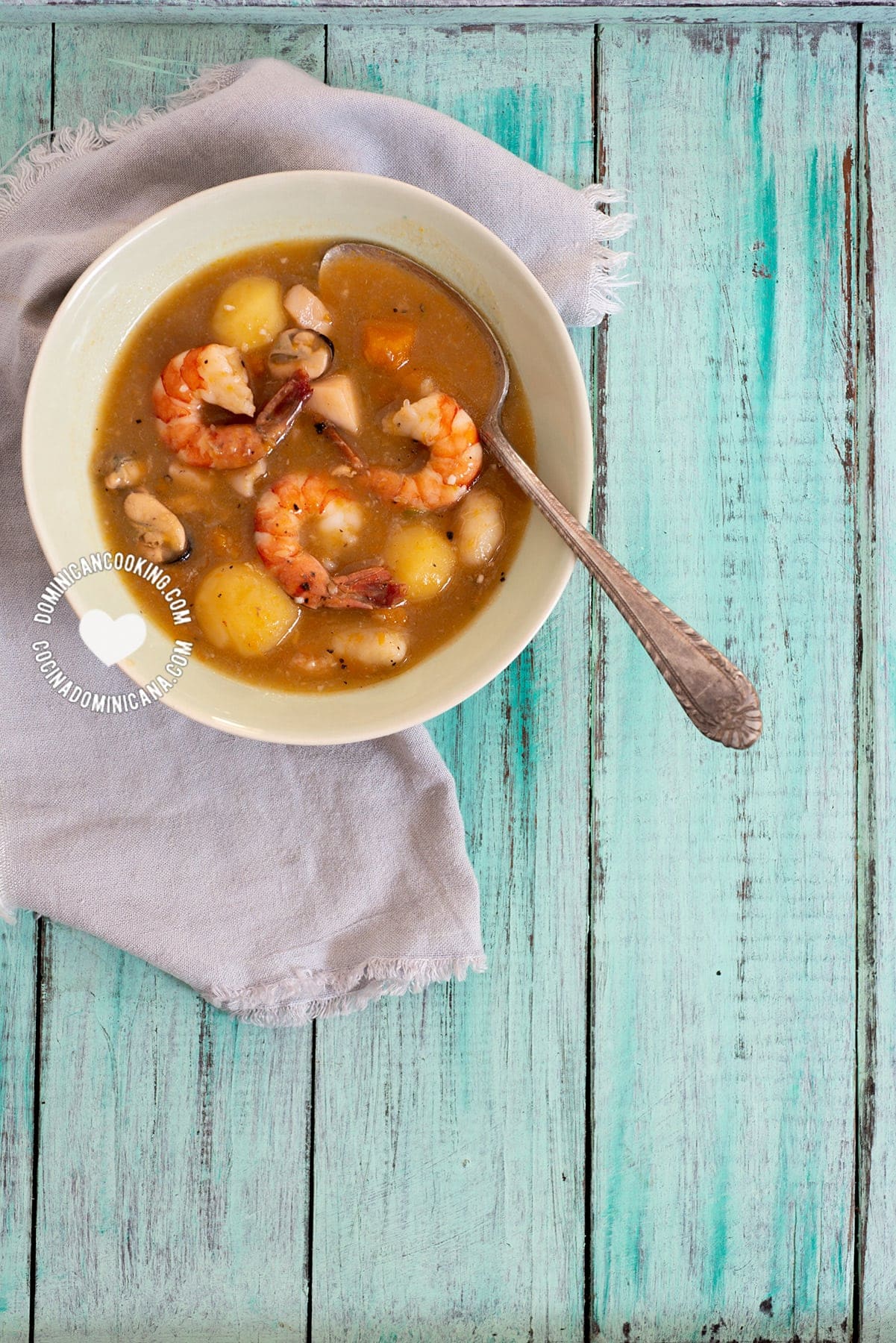 Bowl of "Sancocho" de Mariscos (Shellfish Stew) on Blue Table