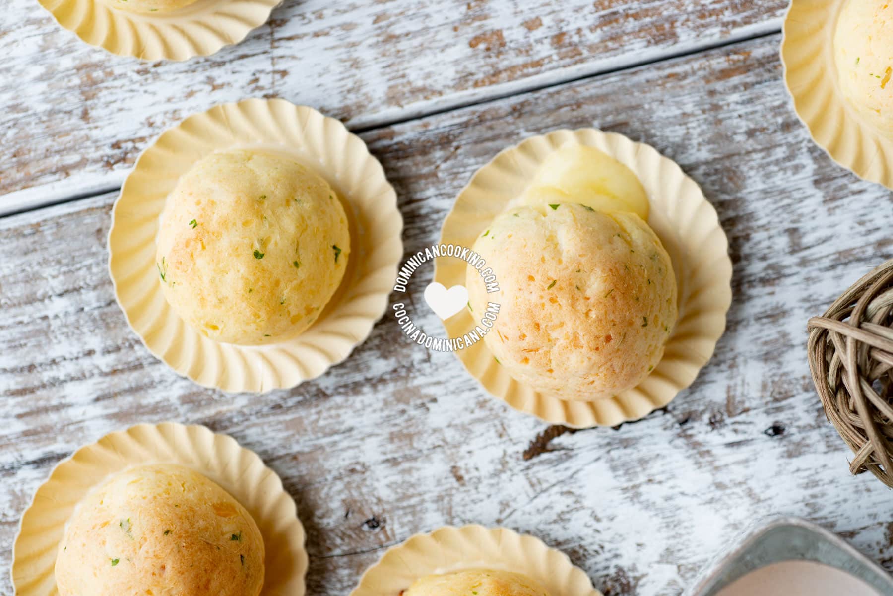 Yuca balls served on tiny paper plates