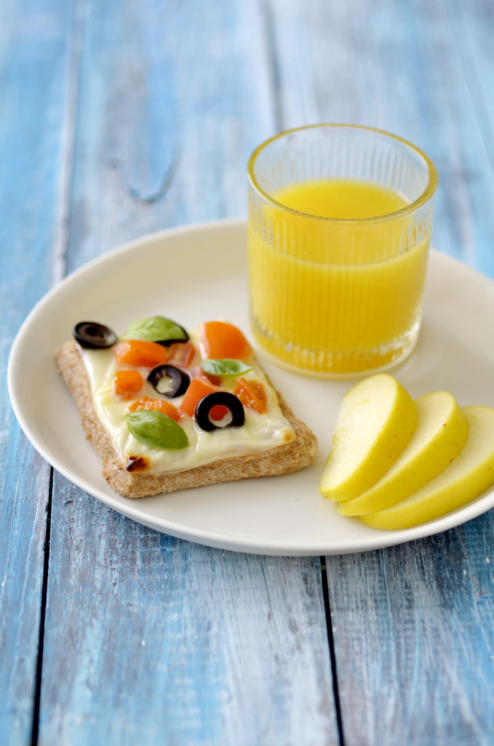 Whole Wheat Cheese and Veggies Tartlet Served with juice and an apple slices