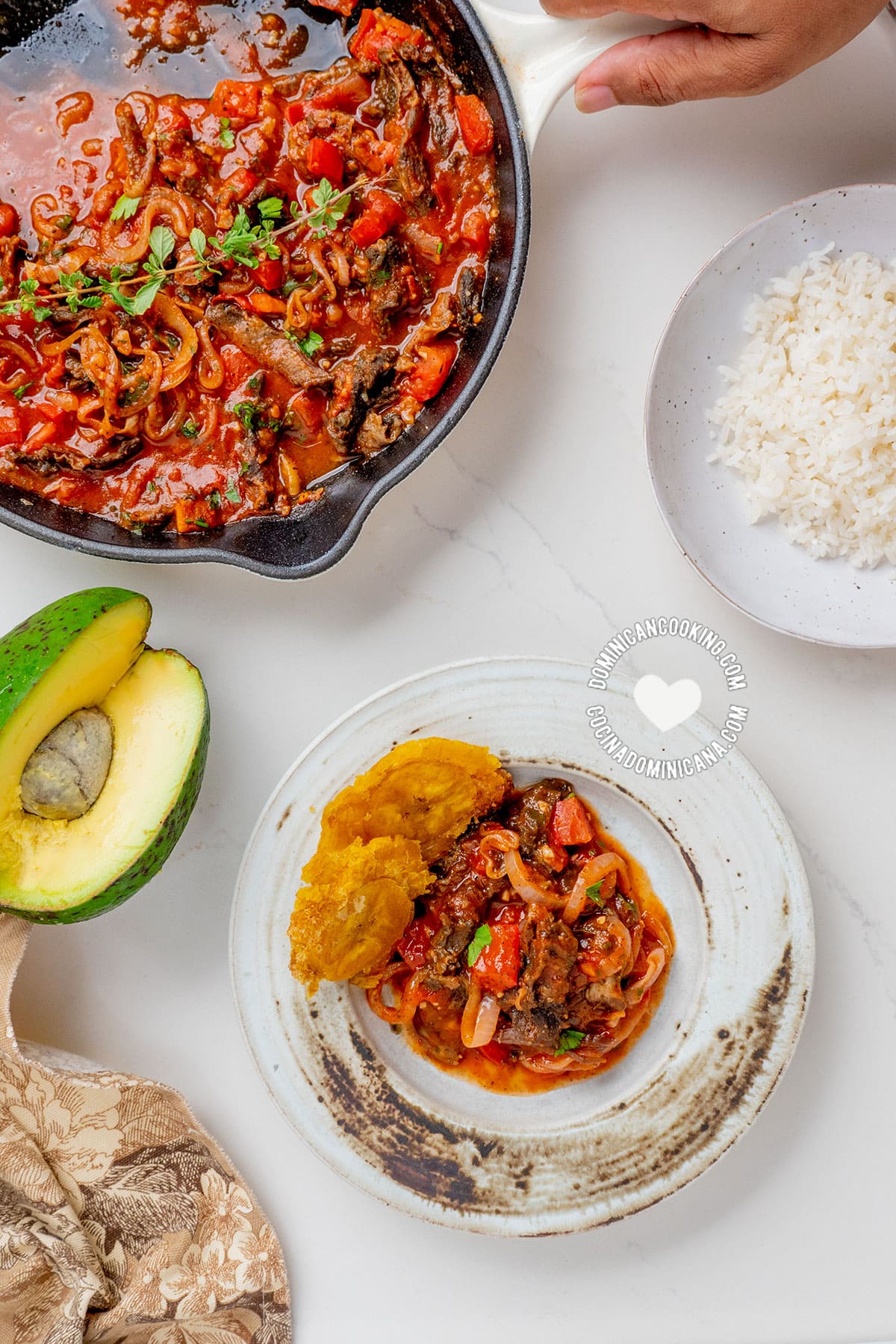 salted goat meat with tostones and avocado