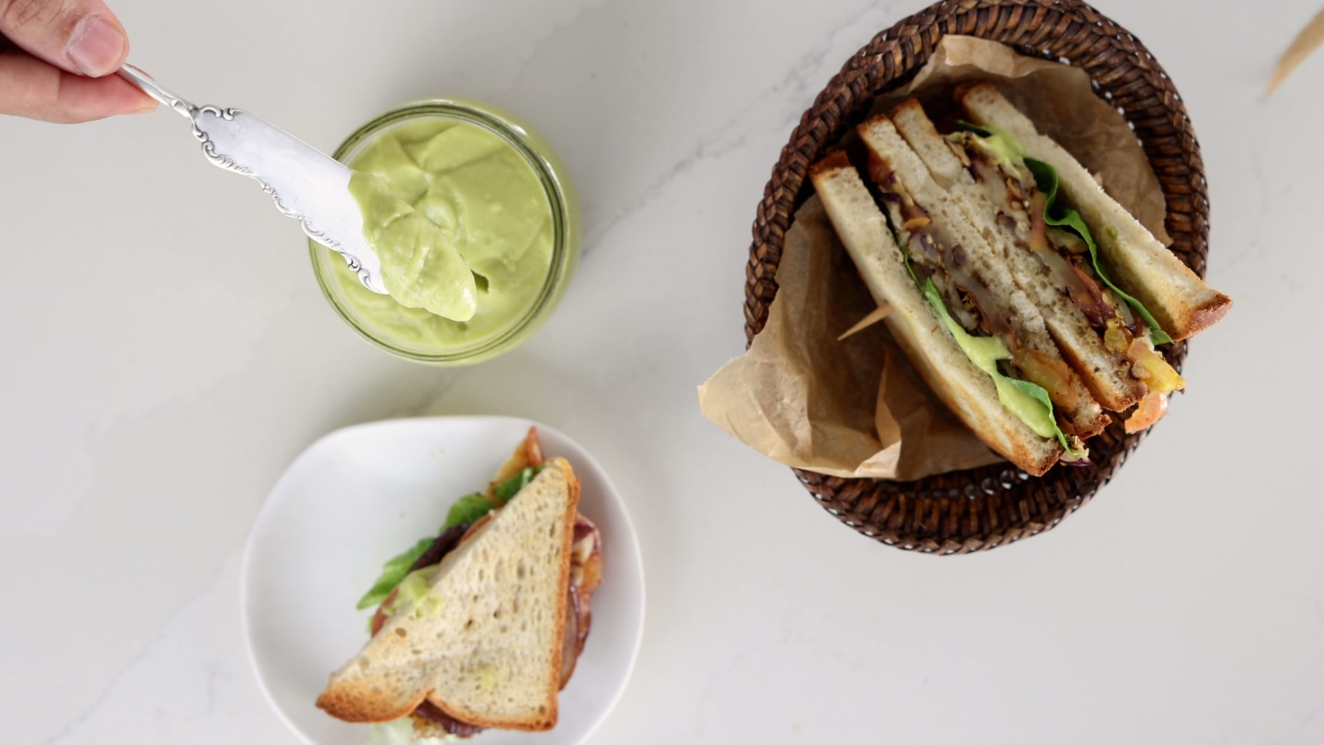 Serving avocado mayo in sandwich