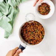 Pot and bowl of lentil and mushroom vegan stuffing for empanadas