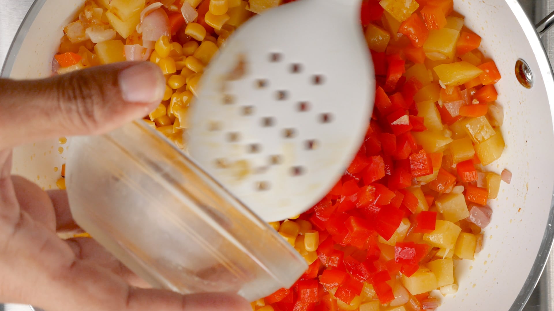 adding corn to the skillet