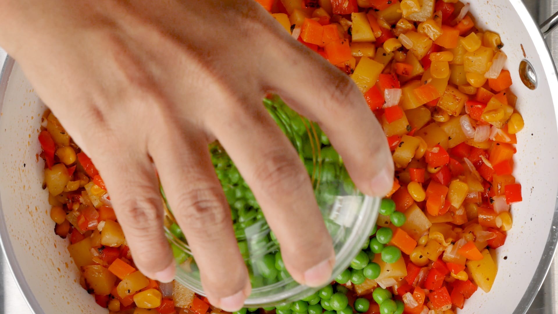 adding peas to the skillet