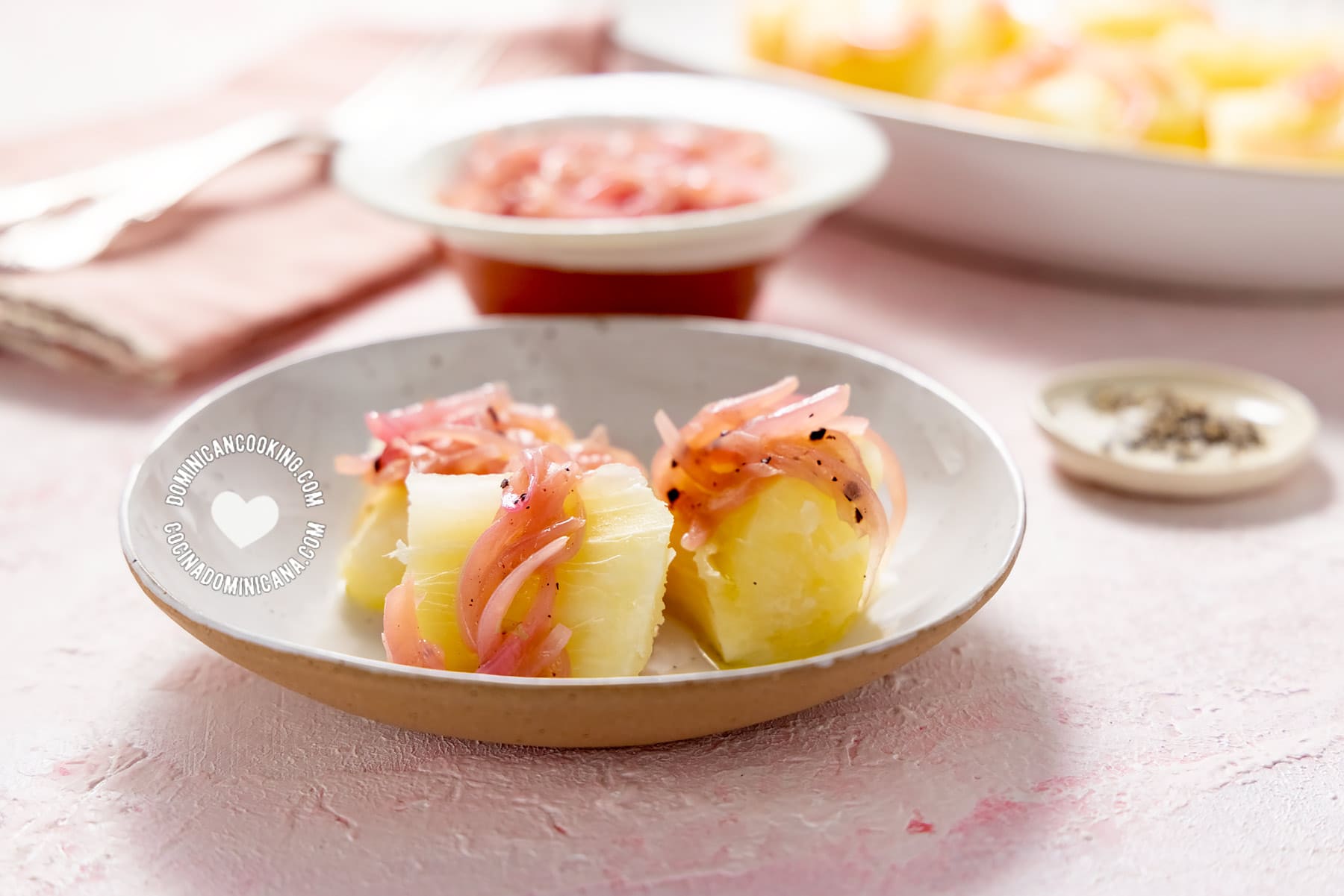 Boiled yuca served with sautéed onions