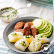 Yuca al Mojo de Ajo (Cassava with Garlic Sauce) served with avocado and longaniza