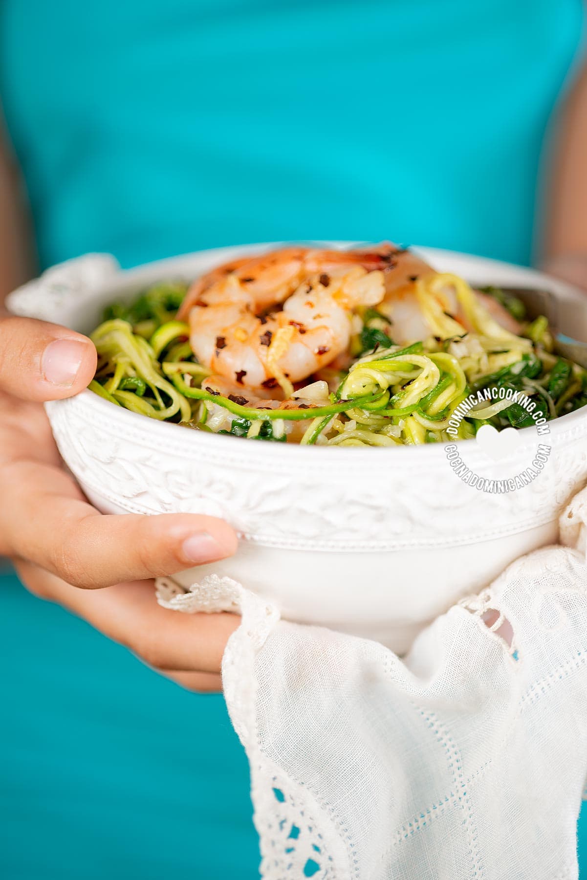 Hands Holding Bowl of zucchini-noodles